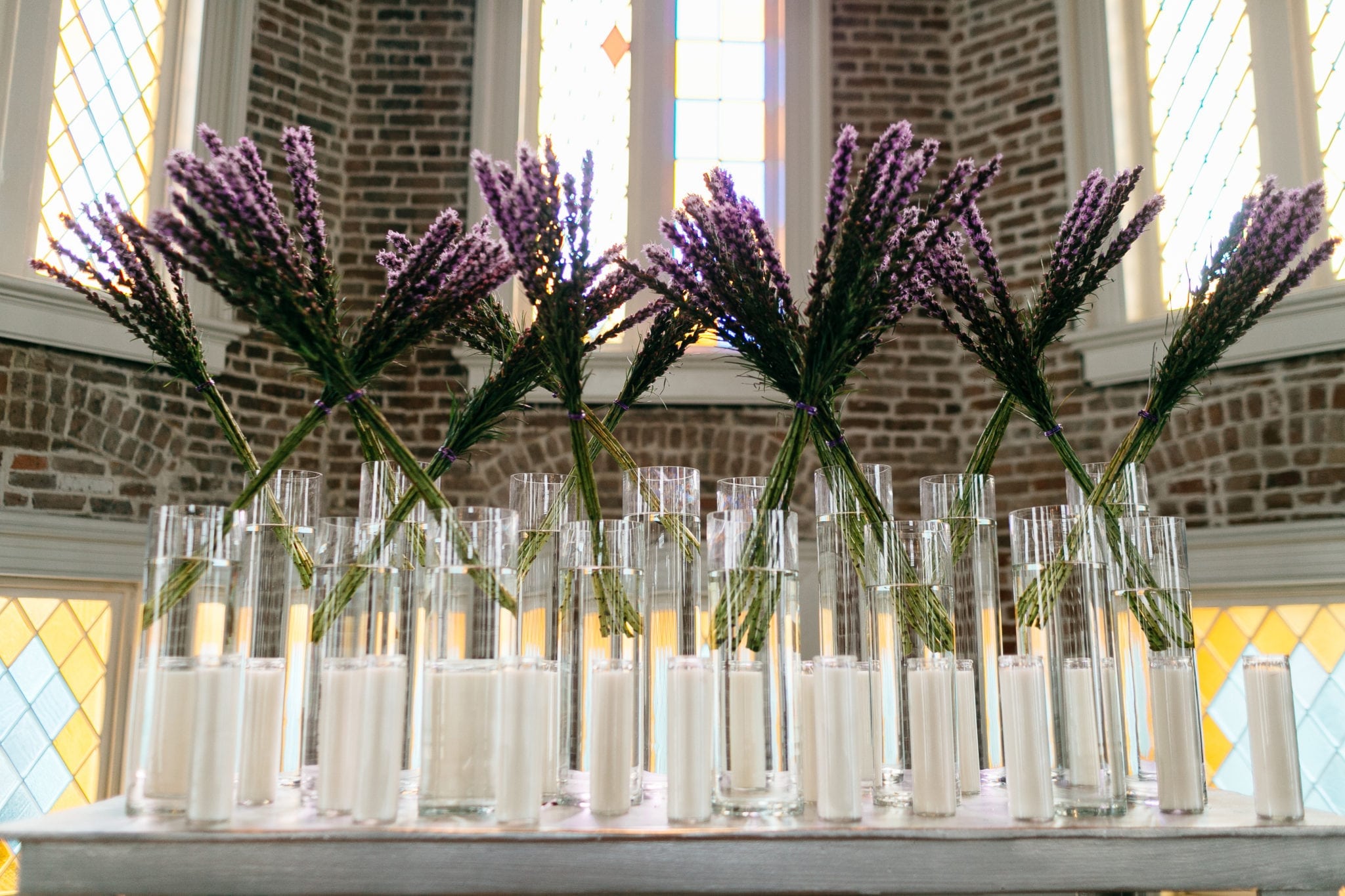 Liatris, tall cylinder, pillar candles, feliciy church, new orleans, stained glass, altar arrangement