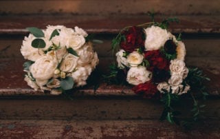 bridal bouquets for lesbian wedding in new orleans include loose and textured bouquet in shades of ivory and burgundy by kim starr wise event florist made another bridal bouquet for same sex wedding celebration in shades of ivory in white with peonies and all the roses