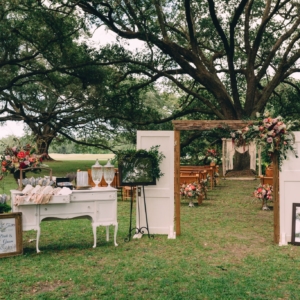 audubon park wedding ceremony welcome sign and arch with wild textural asymmetrical floral arrangement in the top corner -accent-kim-starr-wise-floral-design