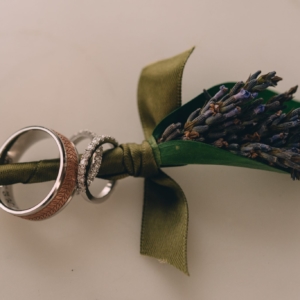 boutonniere with lavender dried green blue leaf wrap kim starr wise floral design