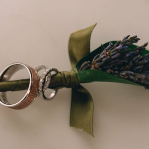 boutonniere with lavender dried green blue leaf wrap kim starr wise floral design