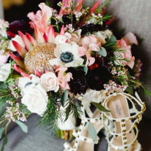 kim starr wise wedding florals in new orleans with bridal bouquet including king protea red anemone wax flower eucalyptus sweet pea