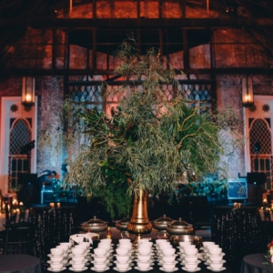 floral decor for big buffet table at wedding reception in new orleans made of lots of greenery and heavy foliage by kim starr wise