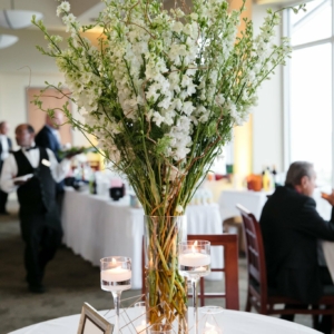 kim starr wise floral events in new orleans spring wedding reception at southern yacht club with floral décor including tall centerpiece larkspur and white delphinium and curly willow