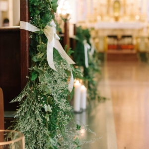 new orleans wedding ceremony cascading foliage pew markers with delicate white flower accents placed every third row beginning at front of aisle by event florist Kim Starr Wise
