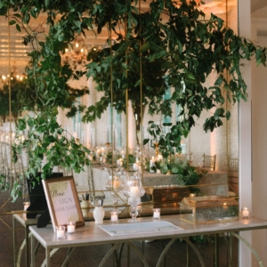 kim starr wise event florist use white flowers and lush greenery to decorate the welcome table at the wedding reception at marche in downtown new orleans