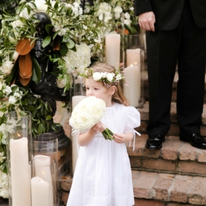 flower girl wears delicate head wreath st charles avenue wedding new orleans louisiana elms mansion blush ivory and white flowers southern winter wedding floral decor by kim starr wise wedding and event florist