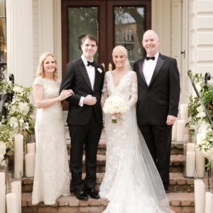outdoor wedding ceremony on st charles avenue in new orleans decorated with lush display of greenery and white florals with magnolia leaves, silk hydrangea, roses for southern wedding in louisiana by kim starr wise event florist oasis sausage garland down railing