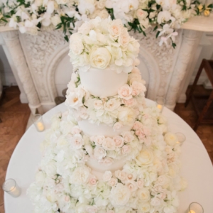blush, white, and ivory wedding cake floral decor with flowers on top and flowers to cover wedding cake stand at st charles ave wedding new orleans southern winter wedding by kim starr wise floral design and event florist