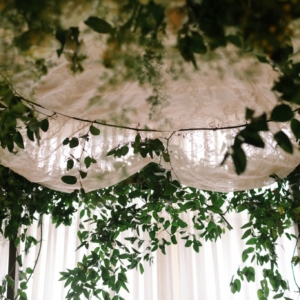 dark natural wood chuppah decor top cluster floral accent smilax vine ceremony marche jewish wedding tallit