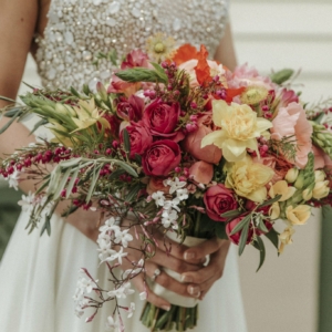 new orleans spring wedding floral arrangements kim starr wise bridal bouquet with peonies, poppies, ranunculus, garden roses, and greenery