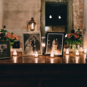 sign-in table at the wedding reception with votive candles and coordinating flower bud vases for september wedding in new orleans by kim starr wise floral events