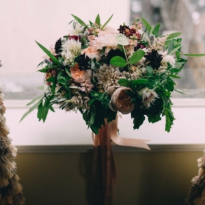 bridal bouquet for fall wedding in new orleans louisiana arrangement with dahlias, scabiosa, stock, ranunculus, blushing bride protea, astilbe, zinnias, foliage, herbs