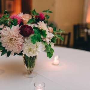 wedding reception centerpiece arrangements to be lush local seasonal blooms with dahlias, roses, protea, scabiosa, ranunculus, hydrangeas, and herbs created by kim starr wise in new orleans louisiana
