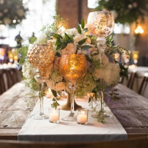 southern wedding reception decor by kim starr wise floral artist how to decorate farm tables for wedding reception using white, nude, beige, blush and pale blue color palate of low lush gold compote, filled with a lush and wild centerpieces in white, nude, beige, blush and pale blue flowers and lots of vines using hydrangea, roses, lisianthus, garden roses, spray roses, peonies, Italian ruscus, queen anne’s lace, tweedia