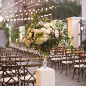floral arrangements for the wedding ceremony included large arrangements on pedestals at the beginning of the aisle in a coordinating color palette of blush, mauve, grey, white, gold, beige and floral design style in clear glass Carol vase by kim starr wise event florist