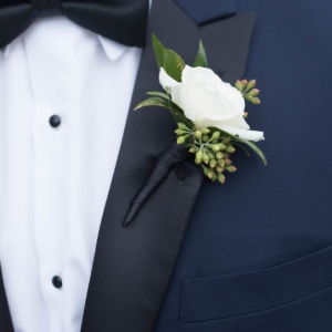 The groom’s wore an ivory spray rose boutonniere to go with his navy tux at new orleans wedding by kim starr wise