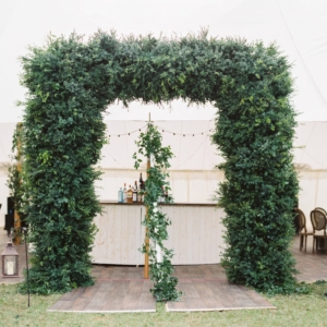 wedding reception tent grand entrance of greenery and foliage on private property in mississippi gulf coast october wedding florals by kim starr wise