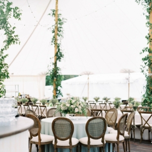 white and green wedding reception tent poles decor smilax vines at mississippi gulf coast wedding in october by kim starr wise floral events