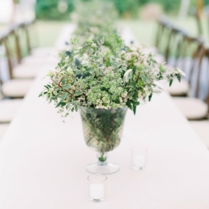 wedding reception table decor lush small compotes containers of all white flowers, blue thistle with green foliage accents