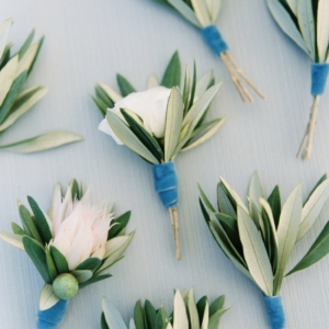 Groomsmen wore simple green and white boutonnieres olive leaf boutonniere finished with a pale dusty blue velvet ribbon created by kim starr wise