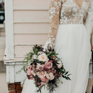 bridal bouquet with lots of movement wild and asymmetrical florals in shades of pale pink mauve and green for french quarter wedding on new years eve by florist kim starr wise