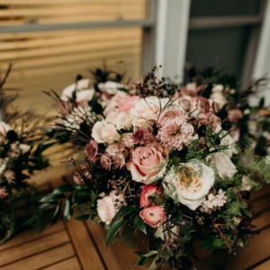 wild and asymmetric bridesmaid bouquets in shades of pale pink mauve and green to be smaller versions of bridal bouquet with wild asymmetrical garden style for new orleans french quarter wedding florals by kim starr wise event florist
