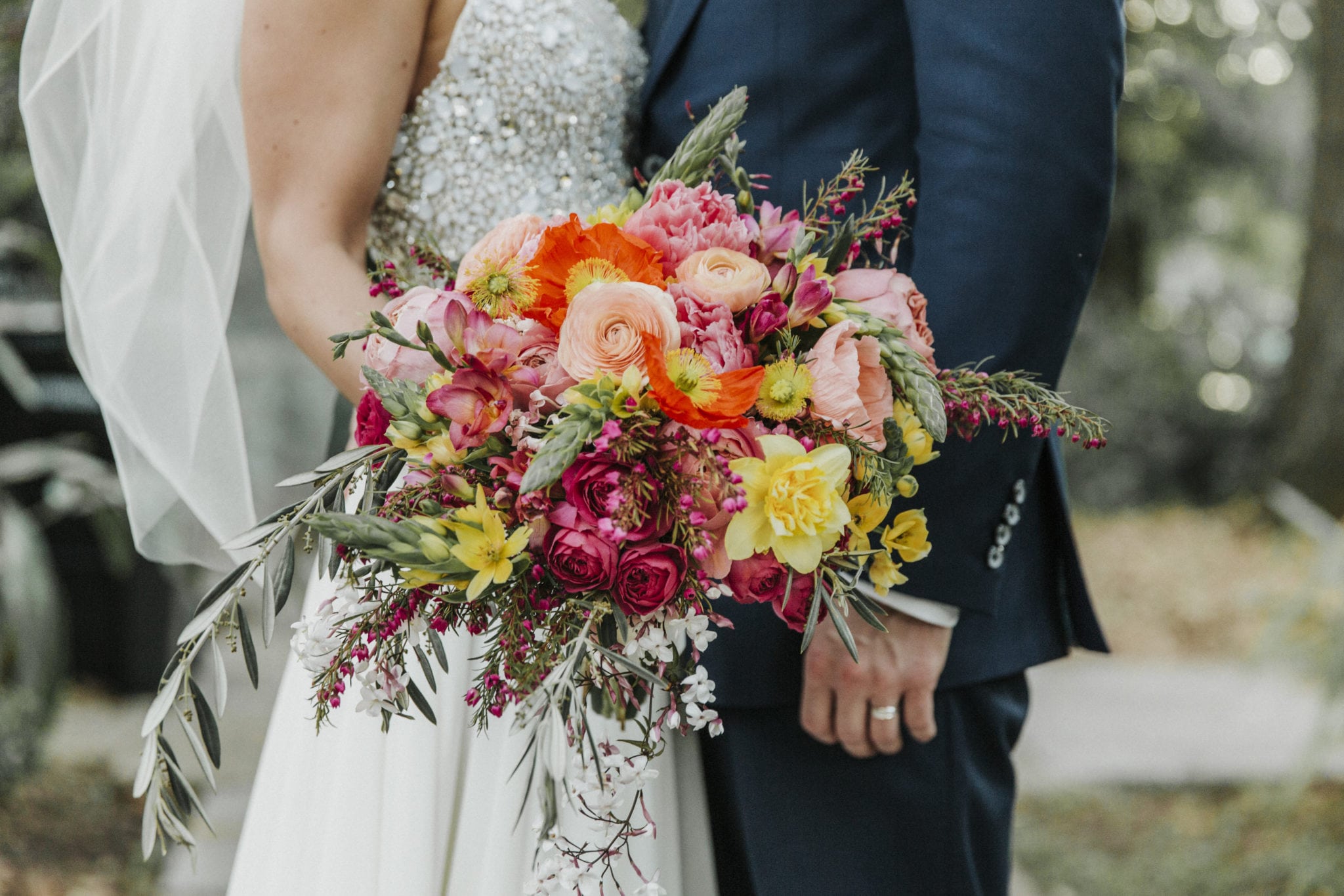 new orleans spring wedding floral arrangements kim starr wise bridal bouquet with a slight cascade in shades of fuchsia orange, peach, blush, and hints of yellow with greenery